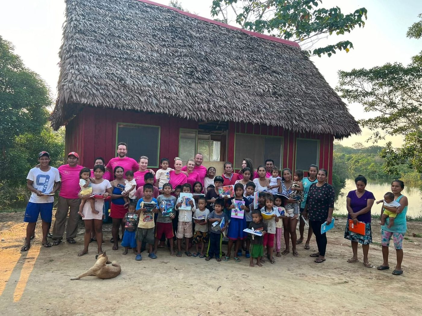 Children from a nearby river village outside the camp building